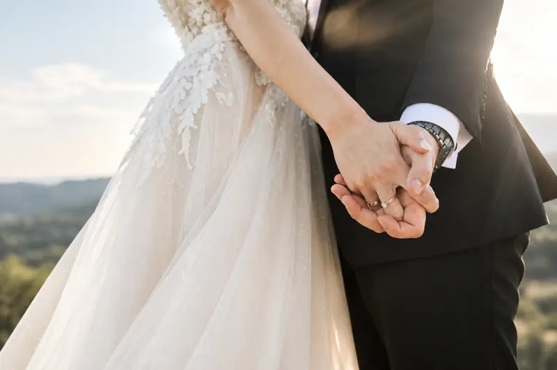 A bride and groom holding hands